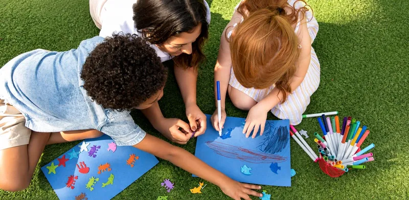 Children coloring on the lawn at Acqualina, home of the AcquaMarine kids club